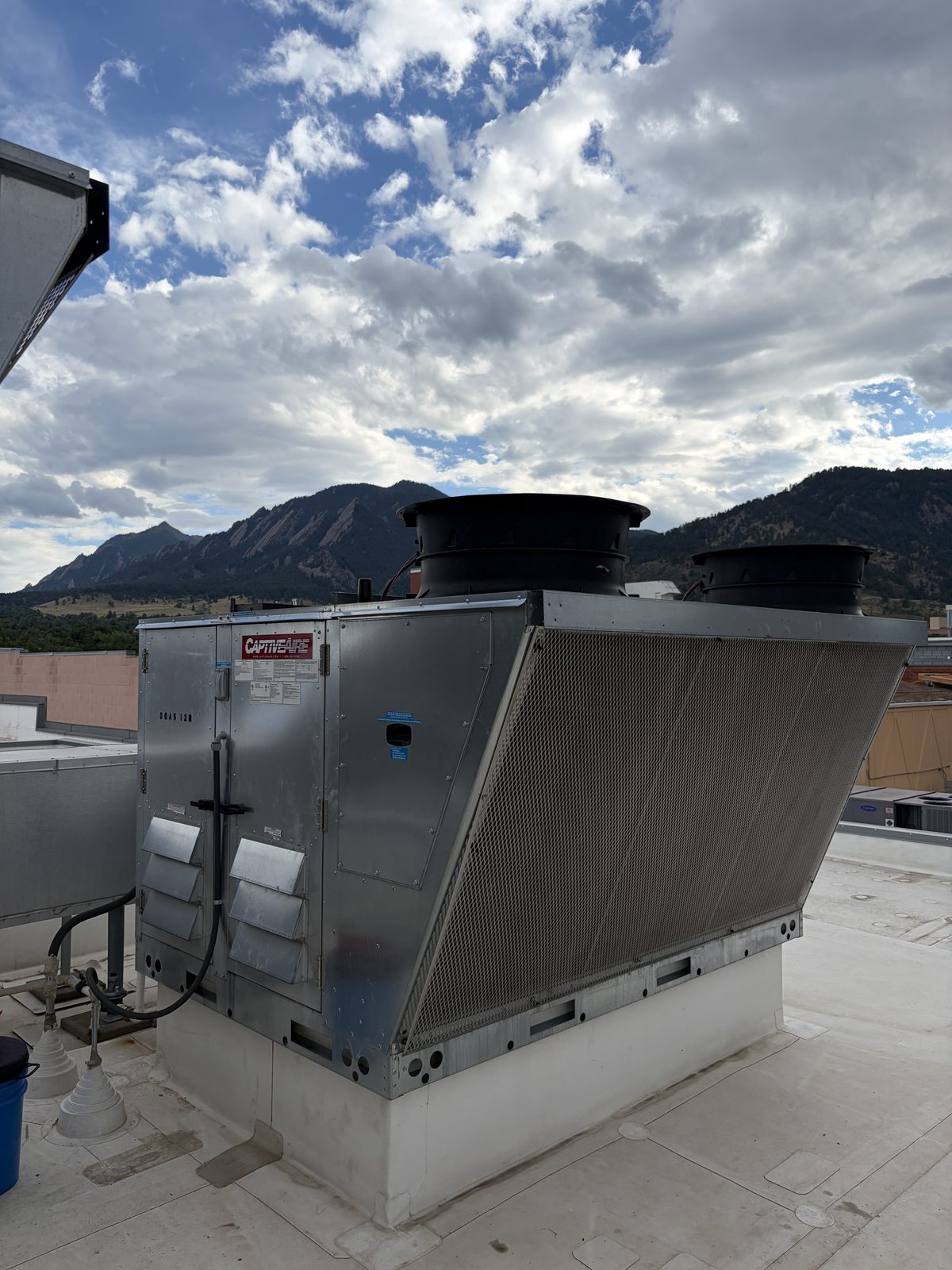 CaptiveAire Paragon rooftop HVAC unit serviced by Longview Heating & Air, with the Colorado Front Range behind it