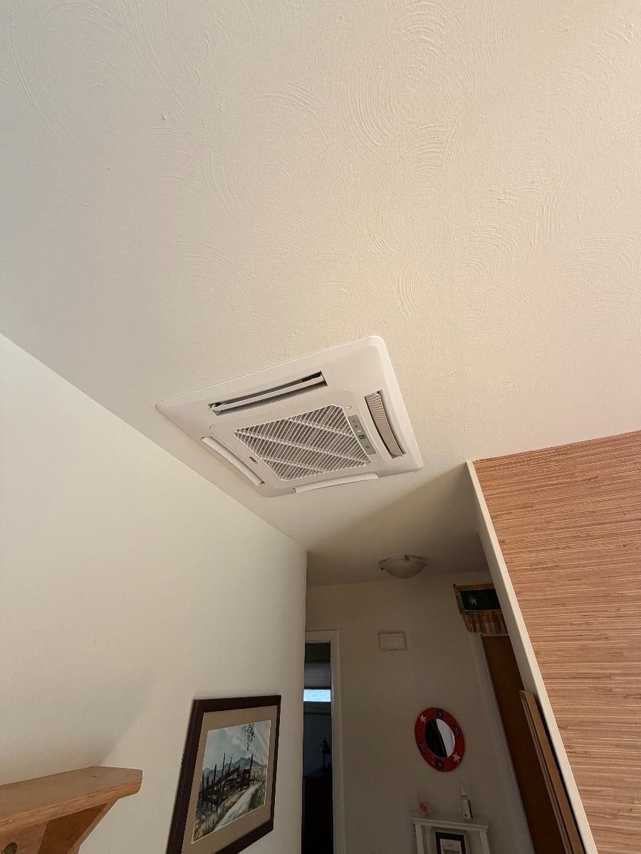 A recessed ceiling-cassette ductless indoor unit installed in a ceiling