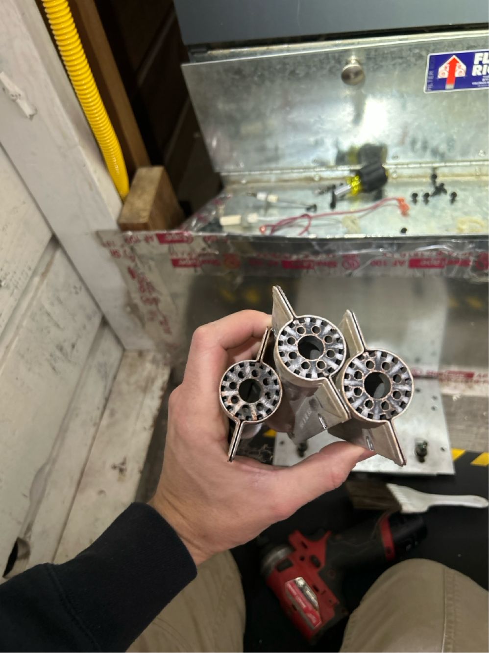 Furnace burners pulled for cleaning during a heating tune-up