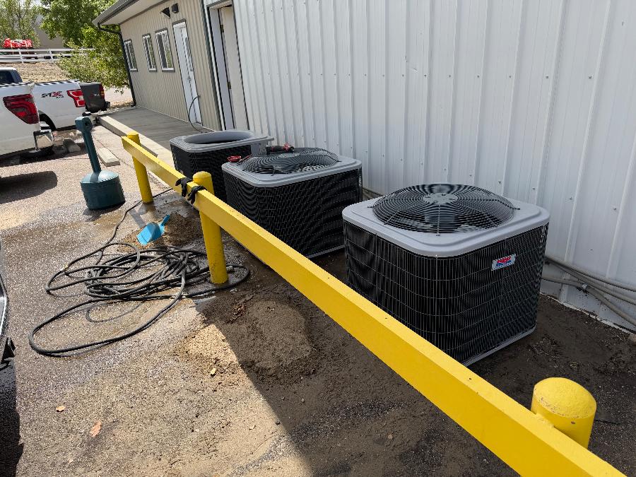 A row of outdoor AC condensers serving a light-commercial building
